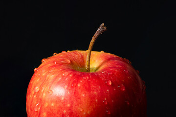 Red apple with water drops on a black background close-up - 783113137
