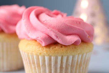 Delicious cupcake with bright cream on light background, closeup