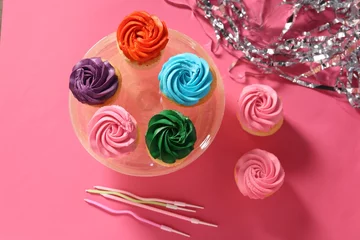 Foto op Aluminium Delicious cupcakes with bright cream, candles and confetti on pink background, flat lay © New Africa
