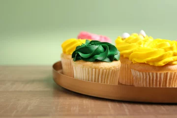 Fotobehang Delicious cupcakes with bright cream on wooden table, closeup. Space for text © New Africa