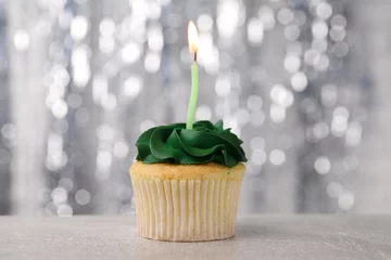  Delicious cupcake with bright cream and burning candle on grey table, closeup © New Africa