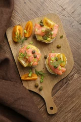Zelfklevend Fotobehang Tasty canapes with salmon served on wooden table, top view © New Africa