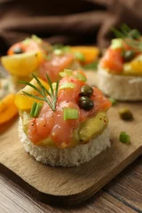  Tasty canapes with salmon served on wooden table, closeup © New Africa