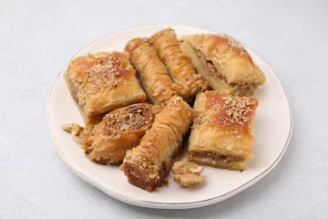 Deurstickers Eastern sweets. Pieces of tasty baklava on white table © New Africa