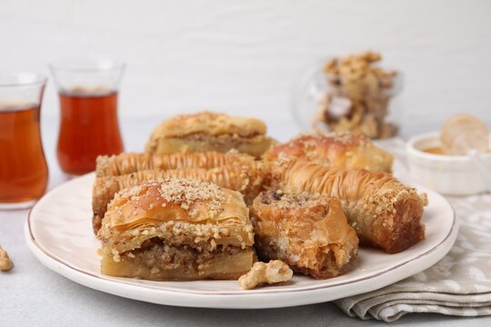 Eastern sweets. Pieces of tasty baklava on white table, closeup