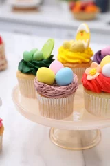 Tuinposter Tasty cupcakes with Easter decor on white marble table © New Africa