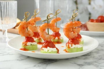 Poster Tasty canapes with shrimps, vegetables and cream cheese on white marble table © New Africa