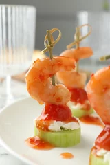Poster Tasty canapes with shrimps, vegetables and cream cheese on white table, closeup © New Africa