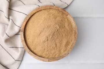 Dietary fiber. Psyllium husk powder in bowl on white table