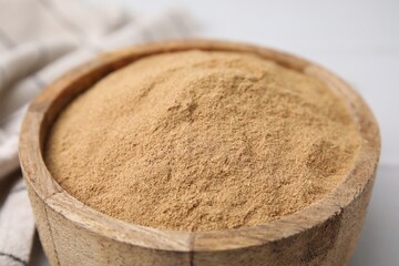 Dietary fiber. Psyllium husk powder in bowl on white table