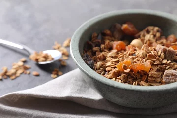 Fotobehang Tasty granola in bowl and napkin on gray table, closeup © New Africa