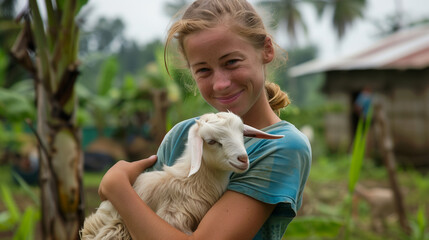 Woman hugging a Nubian goat on an eco-friendly farm.	
