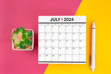 White calendar for July 2024 and pen on beautiful background.