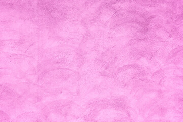 Abstract pink toned painted congrete wall texture as background.