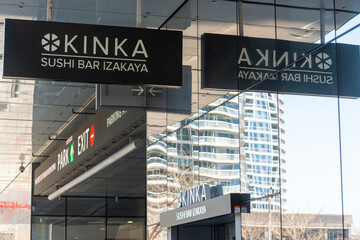 Fototapeta premium exterior building and sign of Kinka Sushi Bar Izakaya Harbourfront, an authentic japanese restaurant, located at 110 Harbour Street in Toronto, Canada