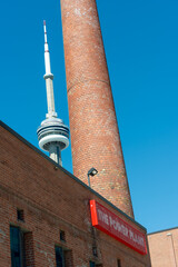 Fototapeta premium CN Tower and exterior building and sign of The Power Plant Contemporary Art Gallery located at 231 Queens Quay West in Toronto, Canada