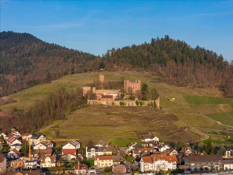 Ortenberg residential area with Ortenberg Castle in spring at sunset, drone shot