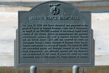 Fototapeta premium close-up of monument plaque with inscription of Shrine Peace Memorial on the grounds of Exhibition Place in Toronto, Canada
