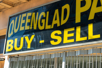 Fototapeta premium vintage box frame sign of Queenglad Pawnbrokers, a pawn shop, located at 1202 Queen Street West in Toronto, Canada