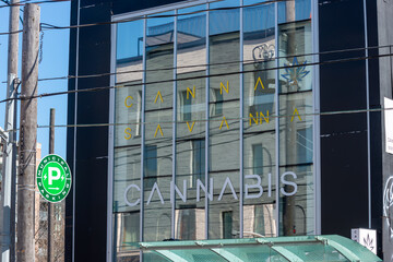 Fototapeta premium exterior building facade and sign of Canna Savanna, a cannabis store, located at 1149 Queen Street West in Toronto, Canada