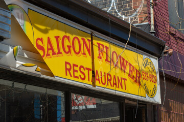 Fototapeta premium old light box sign of Saigon Flower Restaurant, a Vietnamese restaurant, located at 1138 Queen Street West in Toronto, Canada