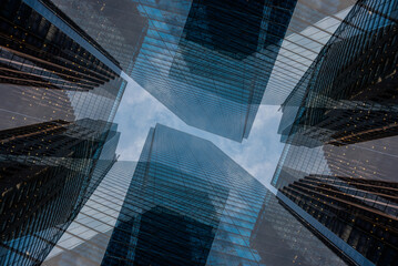 symmetry and mirrored geometry pattern, reflected skyscrapers and modern buildings abstract...
