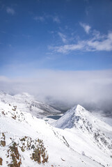 View from Piz Nair, overlooking snow-covered mountains and Lake Suvretta (Lej Suvretta), near St...