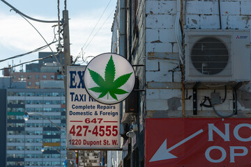 Fototapeta premium projecting signs on old buildings along Dupont Street in Toronto, Canada (Sovereign Smoke, Expert Auto Repairs around 1220 Dupont)