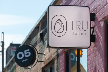 Fototapeta premium exterior projecting sign of TRU tattoo studio located at 1250 Dupont Street in Toronto, Canada