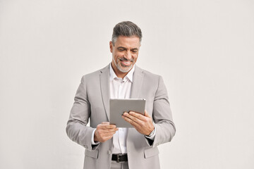 Happy middle aged business man using tablet computer isolated on white wall. Smiling mature businessman holding digital tab, busy middle aged ceo professional executive wearing suit working on device. - 783152576