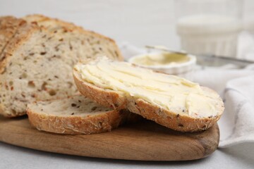 Fototapeta na wymiar Tasty bread with butter on table, closeup