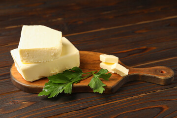 Tasty butter and parsley on wooden table
