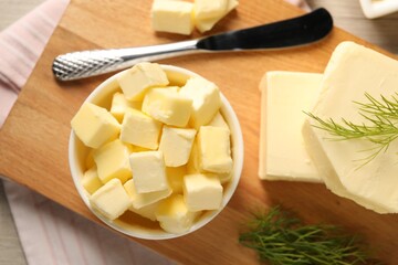 Tasty butter with dill and knife on wooden table, top view
