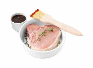 Raw meat, thyme and brush with marinade isolated on white