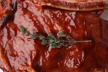 Raw marinated meat with thyme as background, closeup