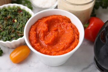 Different marinades in tableware on white table, closeup