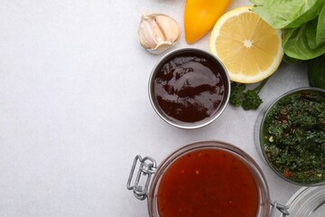 Different marinades and products on light table, flat lay. Space for text