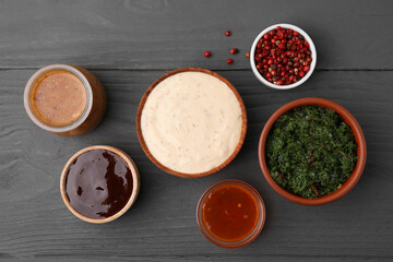 Different fresh marinades on grey wooden table, flat lay