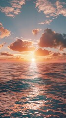 Obraz premium The sun is dipping below the horizon, casting a warm glow over the ocean. The sky is painted in shades of orange and pink, reflecting off the calm waters.