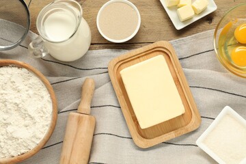 Flat lay composition with fresh butter and other products on wooden table