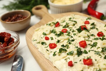 Fresh natural butter board with pepper and parsley on white table, closeup