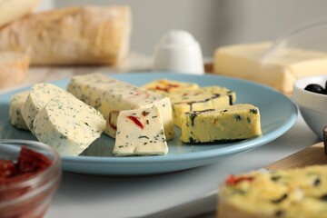 Different types of tasty butter on table, closeup