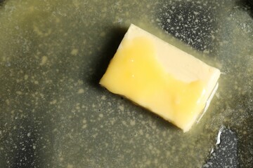 Melting butter in frying pan, top view