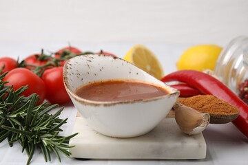 Fresh marinade and different ingredients on white table, closeup