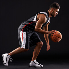 Man, basketball player and playing sport in studio for workout training, black background or mockup space. Male person, running and healthy performance for exercise wellness, practice or professional