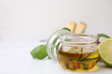 Tasty fish marinade in jar on light tiled table, closeup. Space for text