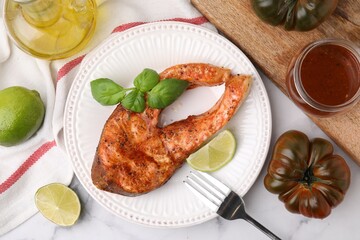 Fresh marinade, cooked fish and other products on white marble table, flat lay