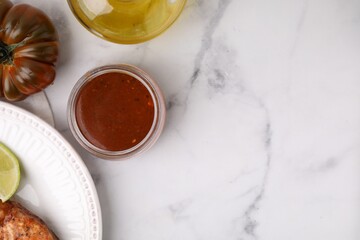 Fresh marinade, cooked fish and other products on white marble table, flat lay. Space for text