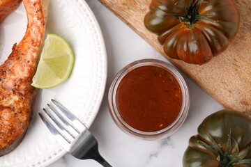 Fresh marinade, cooked fish and other products on white marble table, flat lay