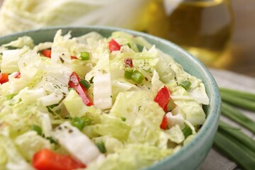 Tasty salad with Chinese cabbage in bowl on table, closeup